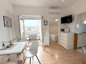 a kitchen and living room with a view of a balcony at Apartments Antic 1 in Pješčana Uvala