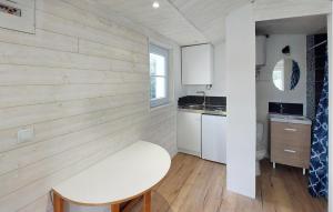 a small kitchen with a white bench in a room at Awesome Home In Barbatre in Barbâtre