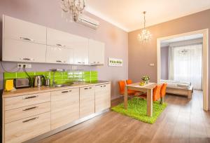 a kitchen with a table and a dining room at Two Couples Apartment in Budapest