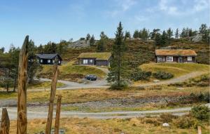 a house on a hill with a car on a road at Gorgeous Home In Kvam With Sauna in Kvam