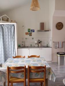 a kitchen with a table and chairs in a room at Gite Le Gripeau in Apremont +13 photos
