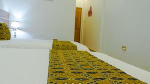 Postel nebo postele na pokoji v ubytování Ambrosia Heights Entebbe