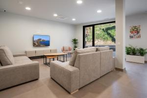 a living room with two couches and a table at Albergue Sancho El Fuerte in Tudela