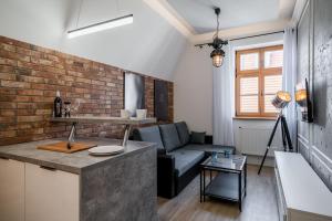 a kitchen and living room with a brick wall at Rynek 2B - Old Town in Wrocław