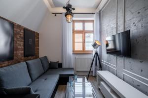 a living room with a couch and a tv at Rynek 2B - Old Town in Wrocław