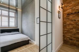 a bedroom with a bed and a brick wall at Rynek 2B - Old Town in Wrocław