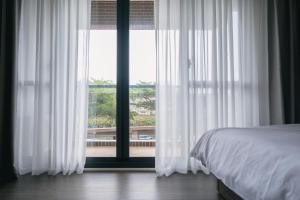 Postel nebo postele na pokoji v ubytování 沐樂旅舍 MLbnb 南投集集 包棟民宿