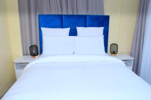 Postel nebo postele na pokoji v ubytování Suprime Hotels and Conference