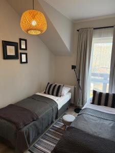 Postel nebo postele na pokoji v ubytování Piękne miejsca przy deptaku Mountain Aparts