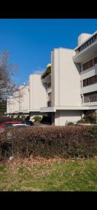 a large white building with cars parked in front of it at Room& Breakfast Martin's Luxury Bologna in Bologna