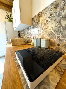 a kitchen with a stove top oven sitting on a counter at Kalma - Universita Bastione Saint Remy in Cagliari
