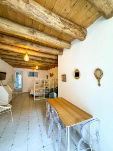 a dining room with a wooden table and chairs at Kalma - Universita Bastione Saint Remy in Cagliari