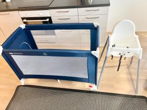 a large blue box in a kitchen with a chair at City Home Finland Arena Suite - Perfect location with City View in Tampere