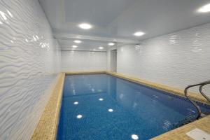 a large swimming pool in a building at The Tower Hotel Tashkent by HotelPro Group in Tashkent