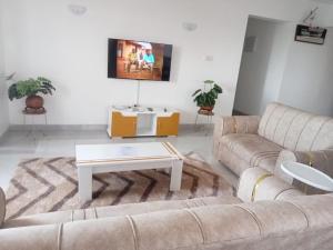 a living room with a couch and a coffee table at Kheyre Nyali Ocean View Two Bedrooms Apartments in Mombasa