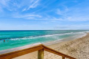 a view of a beach with people in the ocean at Azure Haven in Lantana