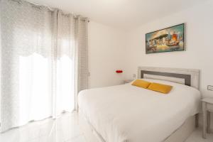 a white bedroom with a bed and a window at WELCS CASA ADOSADA 215 EMP con piscina comunitaria in Roses +24 photos