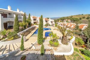 an aerial view of a villa with a swimming pool and trees at WELCS CASA ADOSADA 215 EMP con piscina comunitaria in Roses