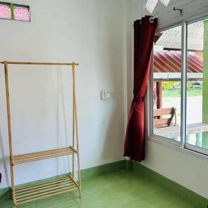 a room with a ladder next to a window at Lamsai AC Sea House Green in Ko Yao Noi +3 photos