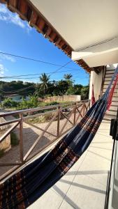 a hammock on a house with a view of the ocean at Suíte House Pipa in Pipa +36 photos