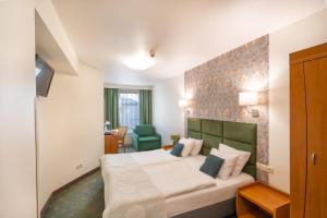 Posteľ alebo postele v izbe v ubytovaní Hotel Secesja