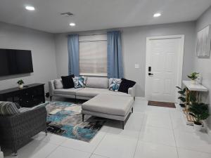 a living room with a couch and a tv at Green Keys Ranch in Homestead