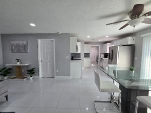 a white kitchen with a ceiling fan and a counter at Green Keys Ranch in Homestead