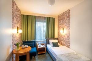 Posteľ alebo postele v izbe v ubytovaní Hotel Secesja