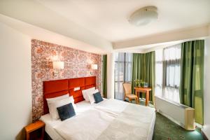 Posteľ alebo postele v izbe v ubytovaní Hotel Secesja