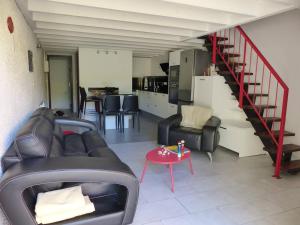 a living room with a couch and a table at HOSSEGOR Entre lac et océan Résidence LES DUNES, villa patio pour 4 à 5 personnes in Hossegor +10 photos