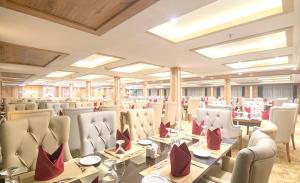 a restaurant with a long table and chairs at Luxor Or Aswan Nile Cruise, Ultra Deluxe sailing 3, 4, Or 7 Nights in Luxor