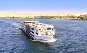 a cruise ship traveling down a river at Luxor Or Aswan Nile Cruise, Ultra Deluxe sailing 3, 4, Or 7 Nights in Luxor