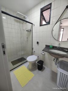 un bagno con doccia, WC e lavandino di Excelente apartamento com vaga garagem a 50 metros da orla da Praia do Morro Guarapari a Guarapari