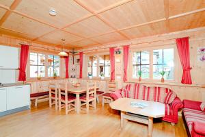 a living room with a table and a dining room at Ferienhaus Eberharter in Schwendau