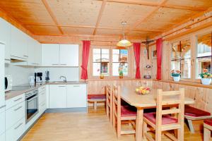 a kitchen with a wooden table and chairs at Ferienhaus Eberharter in Schwendau