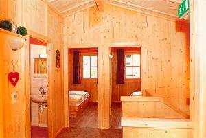 a wooden bathroom with a sink and a toilet at Ferienhaus Eberharter in Schwendau