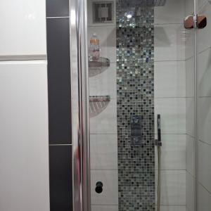 a bathroom with a shower with a tiled shower at Apartament Agnes in Gniezno +15 photos