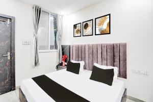 a bedroom with a large white bed with two pillows at The Byke Express - Avanti Residency - Ujjain in Ujjain