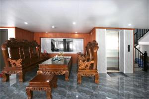 a living room with two chairs and a table at Khách sạn Tiến Đạt in Mèo Vạc