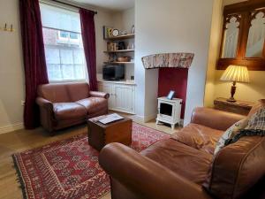 a living room with a couch and a fireplace at 7 Monk Bar Court YORK in York
