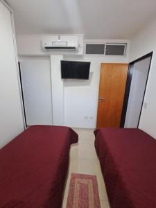 Cette petite chambre comprend 2 lits et une porte. dans l'établissement rocamora, à Posadas