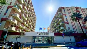 deux grands immeubles avec une enseigne d'hôtel devant. dans l'établissement Mar Benalmadena II - Jupiter, à Benalmádena