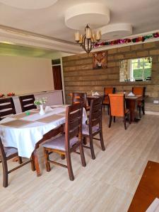 a dining room with a table and chairs at The GreenTulip Gardens in Nkubu +35 photos