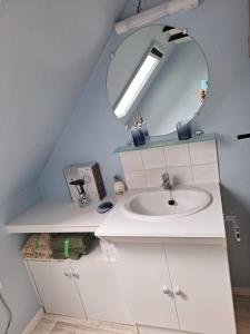 a bathroom with a sink and a mirror at An Doenn Du in Bégard +16 photos