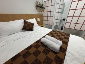 a bedroom with a large white bed with a pillow on it at Florens Inn in Jetis
