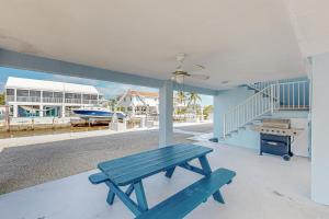 a blue picnic bench sitting on the porch of a house at Seabreeze Haven in Marathon