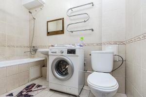 a bathroom with a washing machine and a toilet at Однушка в центре Алматы, до Арбата 5 минут ходьбы #82 in Almaty