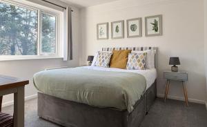 Un dormitorio con una cama grande y una ventana. en Harlowe Mousehole Hideaway two bedrooms with parking, en Mousehole