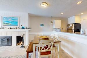 a kitchen and dining room with a table and a fireplace at Great Lakes 11 in Glen Arbor