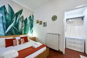 a bedroom with a bed with a large painting on the wall at Rome Bloom - Navona in Rome